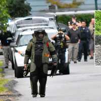 <p>A Bergen County Bomb Squad tech removes the piece of PVC pipe found on a quiet street in Ramsey on Sunday, May 21.</p>