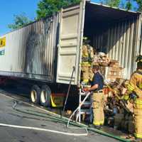 <p>Firefighters tackle the tractor-trailer fire Wednesday afternoon near Exit 9 on I-95 in Stamford.</p>