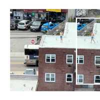 <p>Christopher J. Perez on the roof of the three-story brick building on Palisade Avenue near Washington Place in Cliffside Park where the weekend fire broke out.</p>