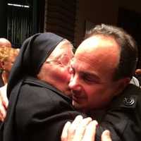 <p>Joe Ganim gets a hug from a nun at his swearing-in ceremony as mayor on Tuesday evening at the Klein Auditorium in Bridgeport. </p>