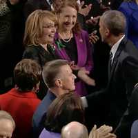 <p>Gabrielle Giffords reaches out to President Barack Obama before the Stat eof the Union Address begins Tuesday night. Giffords, a former Congresswoman and gun violence victim, is sitting with U.S. Rep. Elizabeth Esty (D-Conn., 5th District).</p>