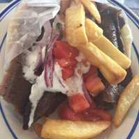 <p>The eponymous gyro is made of meat (normally pork, chicken, beef or lamb) cooked on a vertical rotisserie on a pita and topped with tomatoes, onions and tzatziki sauce made of yogurt, cucumbers and garlic.</p>