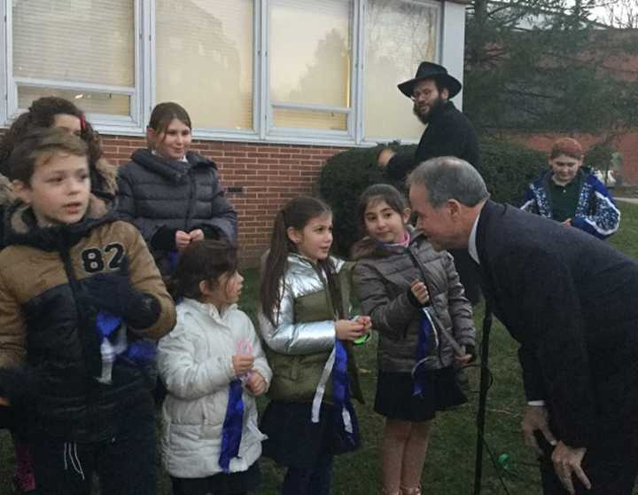 Rockland County Executive Ed Day talks with students from the Chabad Hebrew School at menorah-lighting ceremonies celebrating Hanukkah in New City Tuesday.