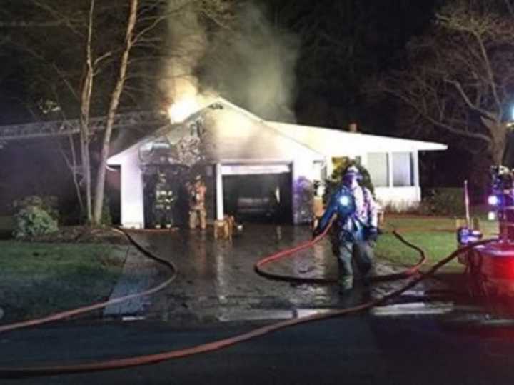 The fire began in a sedan in the garage.