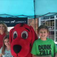 <p>Clifford joins a family for a picture at the festival.</p>
