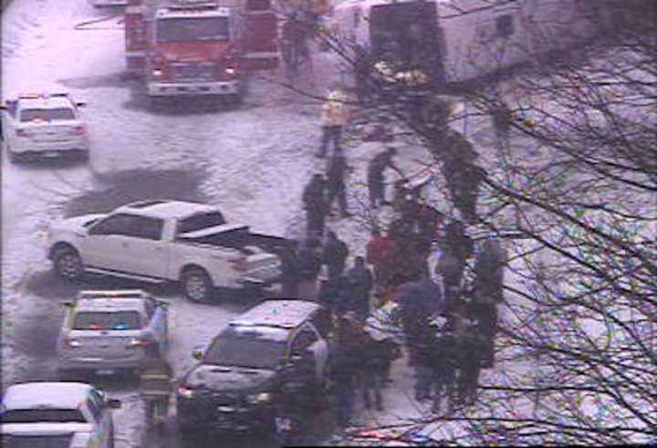 Emergency responders are at work at the scene of an overturned charter bus on I-95 in Madison on Monday afternoon.