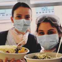 <p>Two workers enjoying healthy meals from Feed the Frontline.</p>