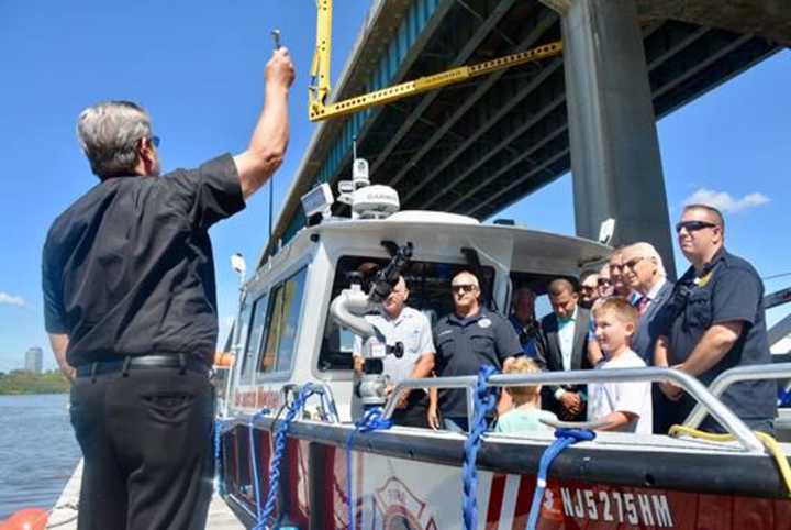 Fire Department Chaplain Father Victor Kennedy blesses Secaucus’ new Marine One firefighting vessel