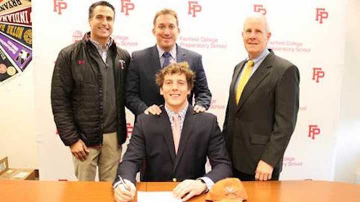 Bobby Haskins with Assistant Coach Mark Cirilli, Head Football Coach Keith Hellstern, and Assistant Football Coach Tom Shea