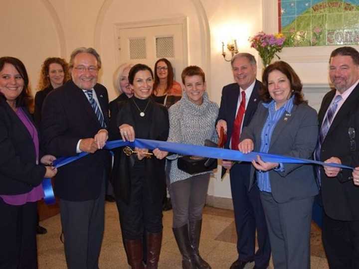 Bergen County Executive Jim Tedesco gets an assist cutting the Empower House ribbon.