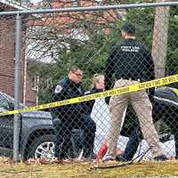 <p>The wounded suspect is tended to on Whiteman Street near Lemoine Avenue in Fort Lee.</p>