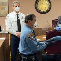 <p>Police Officer Lawrence DiBello Jr. being officially sworn in while his father, Lawrence DiBello Sr., holds the Bible.</p>