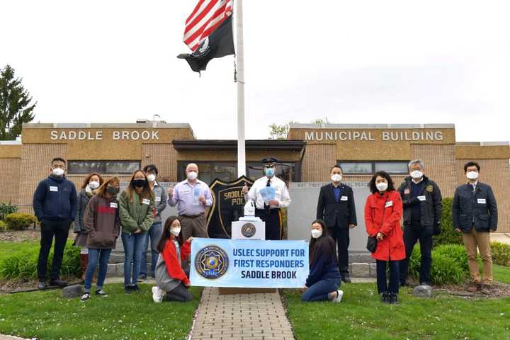 Among those pictured: USLEC Chief Executive Director Daniel Song, USLEC Senior Executive Director John Park, members of the youth internship program (Capt. Angela Song, Lynne Yoon and Josephine Kim), Mayor Robert White, Police Chief Robert Kugler.