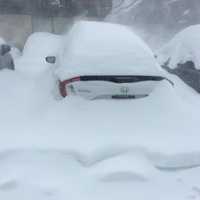 <p>Cars are already buried in Poughkeepsie in a photo taken at noontime.</p>