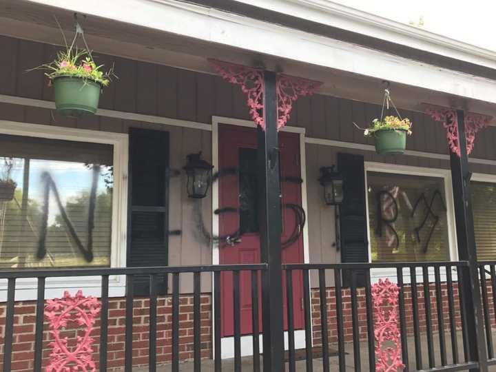 The front of Thompson’s Fine American Comfort Food in New Milford is spray-painted with a racial racial slurs and a swastika.