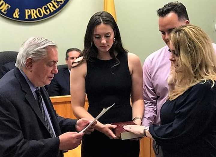 Joined by her children, Sophia and Valentino, new Fairview Councilwoman Violetta Berisha is sworn to office by state Sen. Nicholas Sacco.