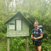 <p>Kristen Geary, a Fairfield resident who is hiking the Appalachian Trail from Georgia to Maine this spring, arrives in Connecticut on Wednesday. The sign along the trail says &quot;Gateway to New England.&quot;</p>