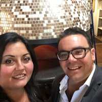 <p>Amore Ristorante owners Sergio and Luisa Ragosta in front of their prized, hand-made, Italian pizza oven.</p>