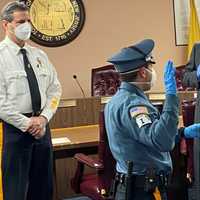 <p>Officer Frank Giordano being sworn in by Mayor Robert White while his mother, Lori Giordano, holds the Bible.</p>