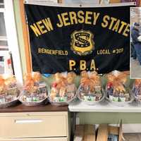 <p>Members of Bergenfield PBA Local 309 assembled and delivered 10 Thanksgiving Day baskets for families in need. INSET (l. to r.): Officers Daynel Ozorio, Andre Enriquez, Tim Knapp.</p>