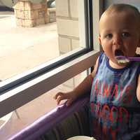 <p>Young Greyson of Oklahoma enjoys frozen yogurt at Cups on Route 3 in Clifton while visiting family.</p>