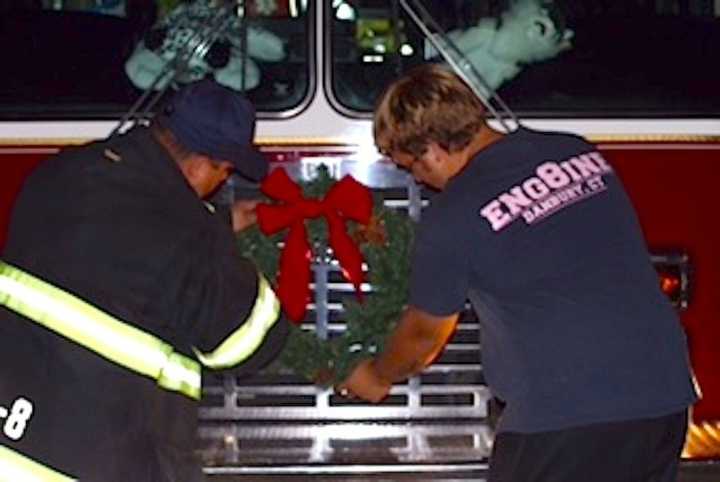 Lt. Chris DiMauro and firefighter Devin Vitti of Phoenix Hose Company #8 putting on the finishing touches for the parade. 