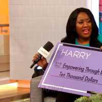 <p>Tanisha Akinloye of Trumbull gets her check from Harry Connick Jr.</p>