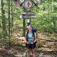 <p>Kristen Geary at the official half-point along the Appalachian Trail — 1,090.5 miles hiked since Georgia and 1,090.5 miles to go to Maine.</p>