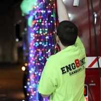 <p>Firefighter Justin Lamontagne of Phoenix Hose Company #8 decorates the truck for the holiday parade. </p>