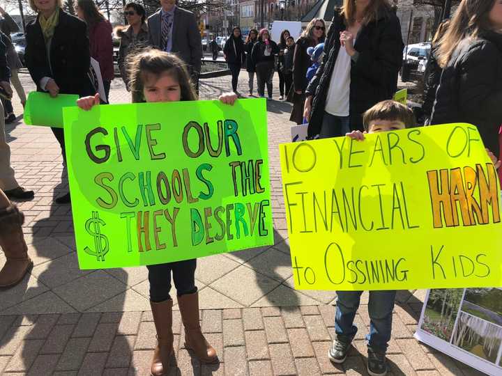 Ossining students, parents and teachers took part in a rally at Market Square on Thursday, March 22 to protest drastic cuts in state aid. Children shouted: &quot;Show me the money,&quot; to Gov. Andrew Cuomo of neighboring New Castle.