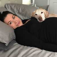 <p>Max lays on a pregnant Jessica Galarza.</p>