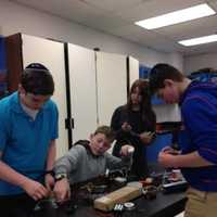 <p>Moriah School of Englewood students and science teacher Sandra Knoll prepare for the Maker Xpo.</p>