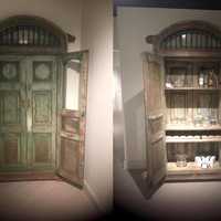 <p>Before (left) and After (right). One-hundred year old doors from India were transformed into a cabinet. Artists worked diligently to match the new back and shelves to the original.</p>