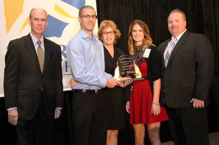 Danielle Kemp, second from right, receives the Chelsea Cohen Courage Award from Cohen&#x27;s twin brother, Daniel, and her mother, Barbara Rittner, in October.