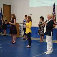 <p>Staff at Pines Bridge School sing at the recent graduation ceremony.</p>