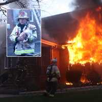 <p>Assistant Lodi Fire Chief Michael Lortz rescues dog.</p>