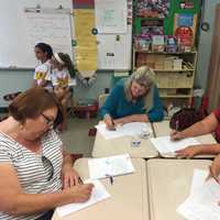 <p>Members of the class of 1975 writes letters to students.</p>