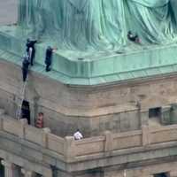 Police Grab Woman After Statue Of Liberty Protest Climb