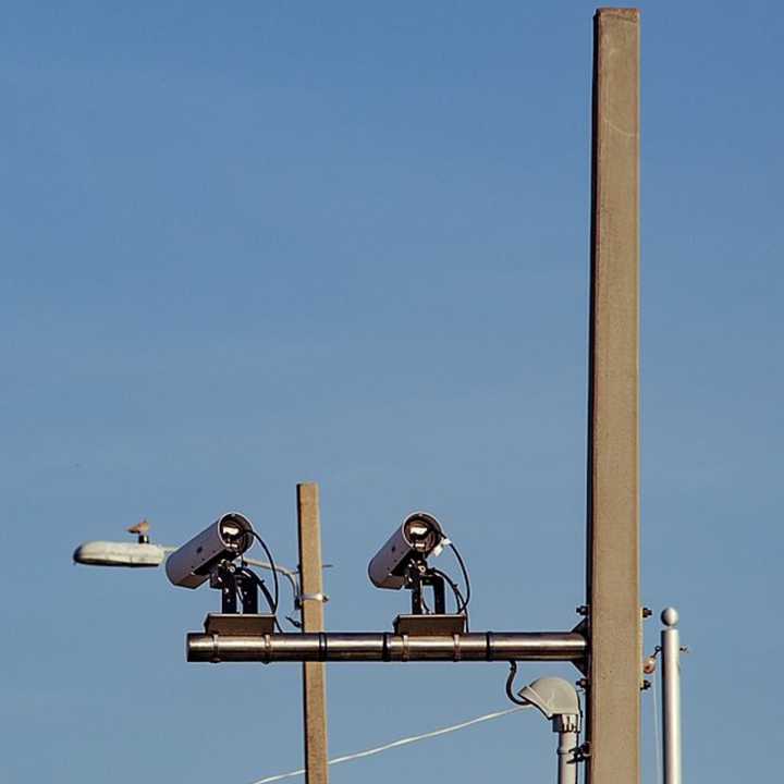 Automated license plate reader cameras scan license plates of cars crossing into Pensacola Beach, Florida.