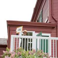 <p>Superintendent Linda Cook prepares to hang &#x27;Spring Landscape,&#x27; the first painting in the restored Weir House.</p>