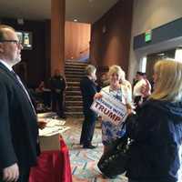 <p>Trump supporters pick up campaign signs in the lobby of the Klein on Saturday morning before the mid-day campaign rally in Bridgeport.</p>