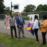 <p>Schenectady Mayor Gary McCarthy unveils a placard commemorating Naylon Carrington at the city&#x27;s Central Park Basketball Court Wednesday, June 22.</p>