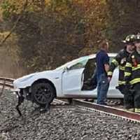 <p>Firefighters at the scene of a sedan struck on the NJ TRANSIT Pascack Valley Line tracks near the Emerson train station.</p>