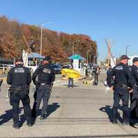 <p>Police watch, bemused, during the protest at Teterboro Airport.</p>