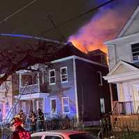 <p>Flames ran up from the basement and through the roof on Harrison Street in Passaic.</p>