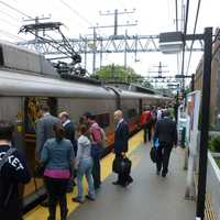 <p>Commuters board trains at the South Norwalk Train Station on Monday.</p>