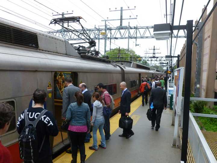 Commuters board trains at the South Norwalk Train Station on Monday.