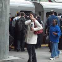 <p>Train riders jam the platform at the Stamford station on Monday morning.</p>