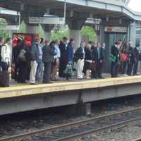 <p>Commuters line up to board a train in Stamford, where trains are running on a normal schedule. </p>