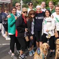 <p>Jenn Marr (Got Comfort shirt) stands with people in Saturday&#x27;s race and comfort dogs Addie and Maggie.</p>